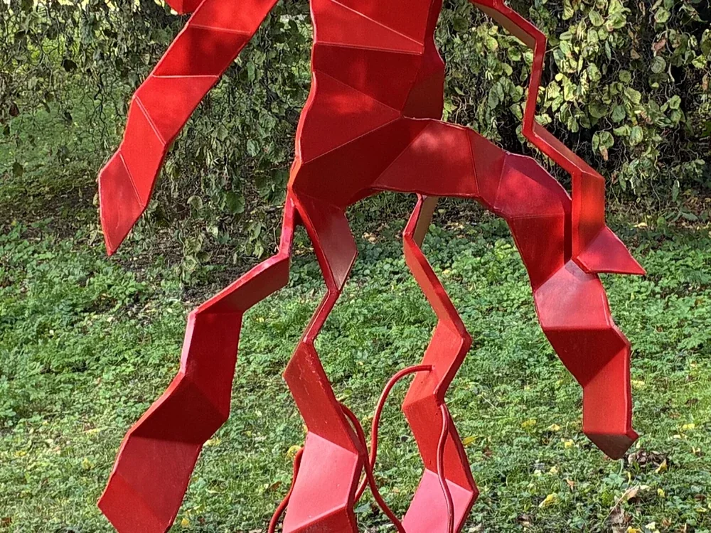 Red sculpture, photographed with the iPhone 17e, centre crop
