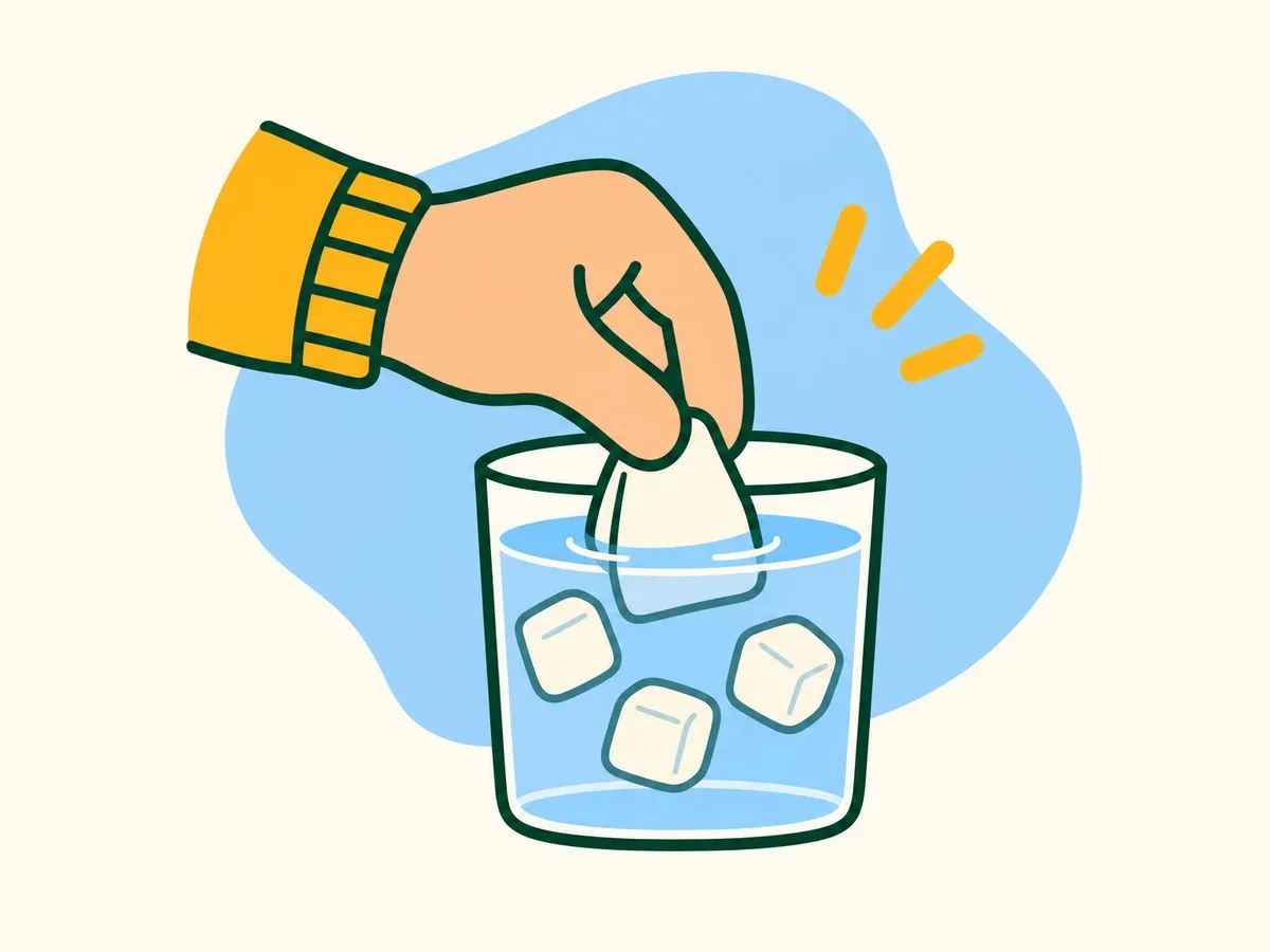 Illustration of a hand dipping a folded square of gauze into a glass of water with ice cubes