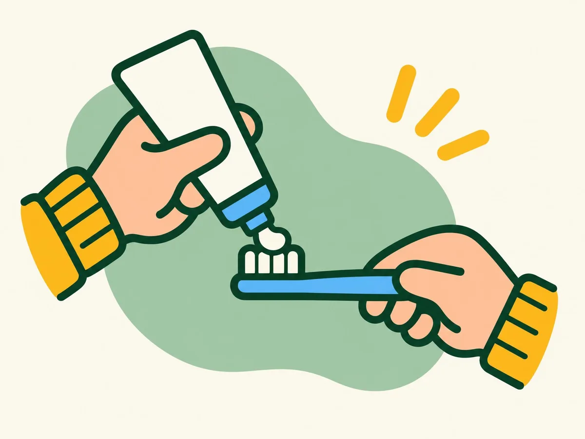 Illustration of a hand squeezing a small pea-sized blob of toothpaste onto a toothbrush